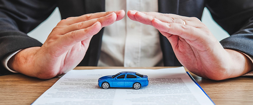 a person protected a toy car with their hands