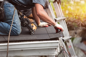 roofer installing shingles